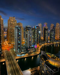 High angle view of illuminated buildings in city at night