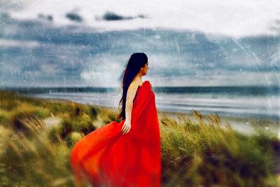 Side view of woman standing on field