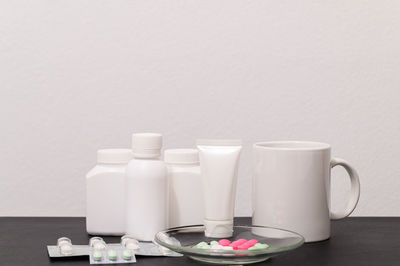 Close-up of coffee cup on table against white background