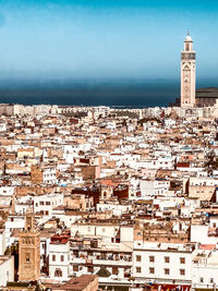 High angle view of townscape by sea against sky