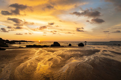 Scenic view of beach against sky during sunset