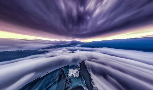 Aerial view of buildings against cloudy sky