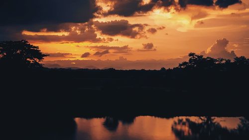 Scenic view of silhouette landscape against sky at sunset