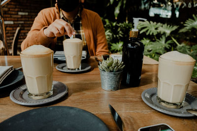 Midsection of woman using mobile phone on table