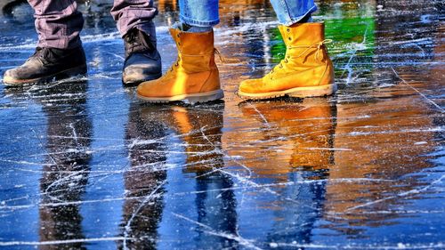 Low section of people standing on ice