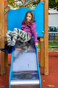 Portrait of girl sitting on slide