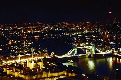 High angle view of illuminated buildings in city at night