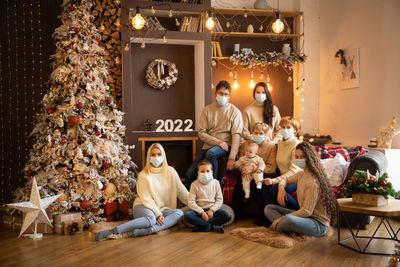 Group of people sitting in illuminated christmas tree