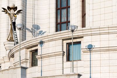 Low angle view of street light against building