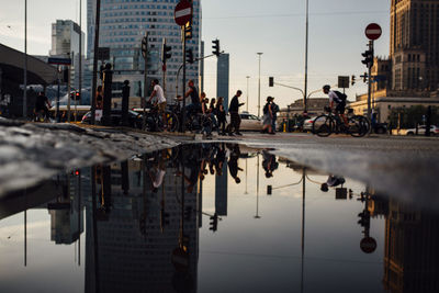 People on street by buildings in city