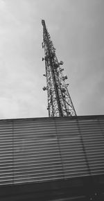 Low angle view of communications tower against sky