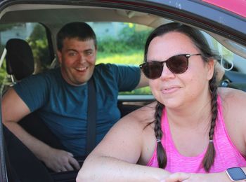 Portrait of smiling woman sitting in car