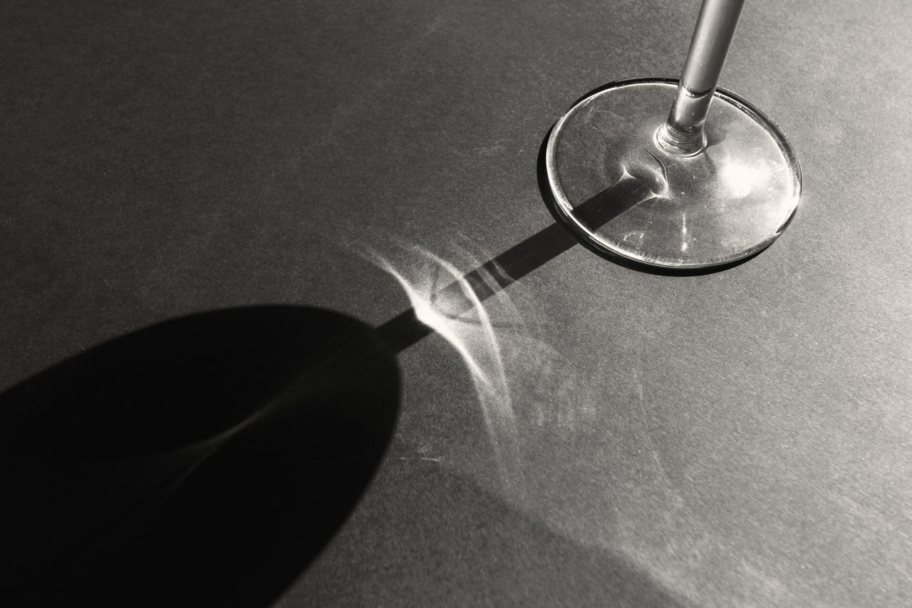 CLOSE-UP OF EYEGLASSES ON GLASS TABLE