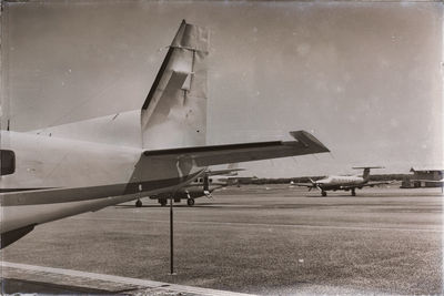 Airplane on airport runway against sky