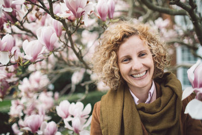 Portrait of smiling woman with pink flowers