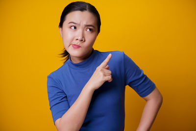 Portrait of boy against yellow background