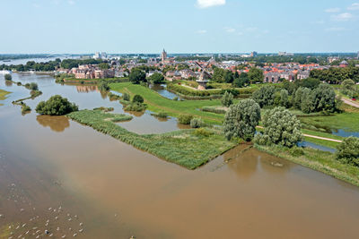 Aerial from the city woudrichem at the river merwede in the netherlands in a flooded landscape