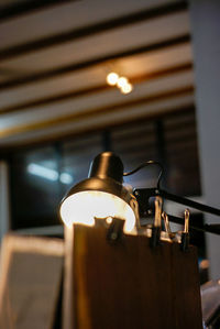 Low angle view of illuminated electric lamp on table in restaurant