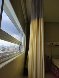 View of railroad tracks seen through window