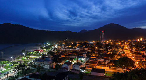 High angle view of illuminated town against sky at night