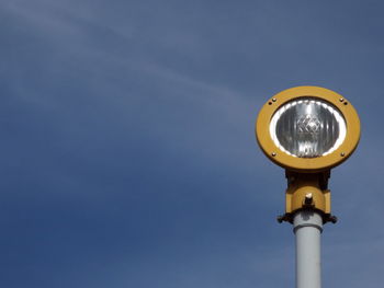 Low angle view of safety light at airport against clear sky