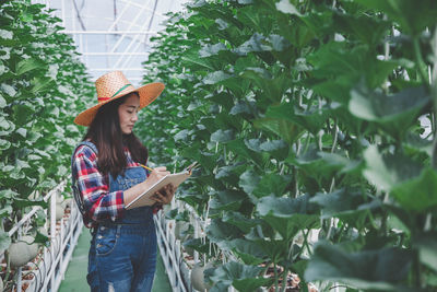 Woman standing by plants