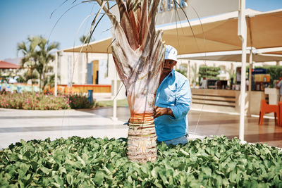 Full length of man standing by plants