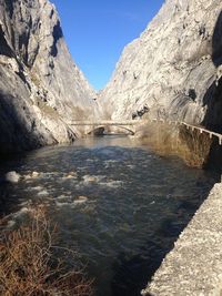 Scenic view of river amidst mountains against clear sky