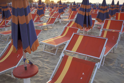 High angle view of empty chairs on beach