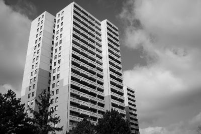 Low angle view of modern building against cloudy sky