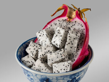 Close-up of fruit in bowl against white background