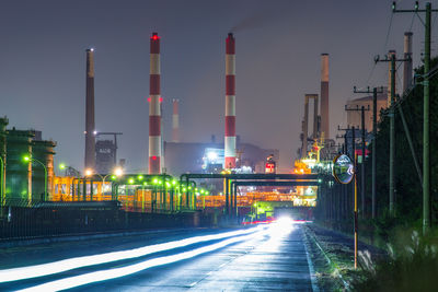 Car light trails in a factory area at night