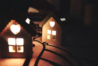 Low angle view of illuminated lamp hanging on wall