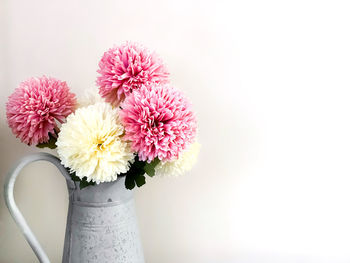 Close-up of pink flower vase against white background