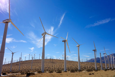 Wind turbines against blue sky