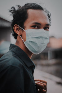 Portrait of young man wearing mask