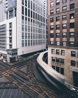 Train on tracks amidst buildings