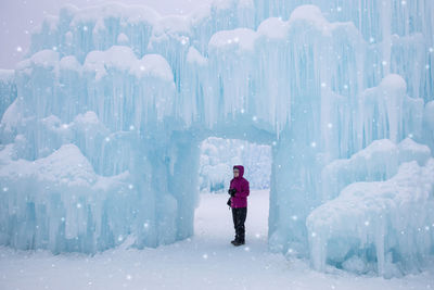 Full length of woman standing on snow during winter