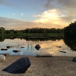 Scenic view of calm lake at sunset