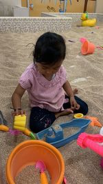 High angle view of boy playing with toys at home