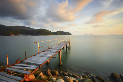 High angle view of broken pier over sea against sky