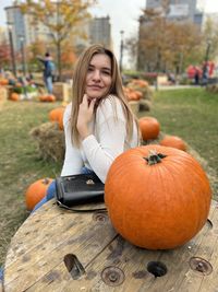 Portrait of young woman holding pumpkin