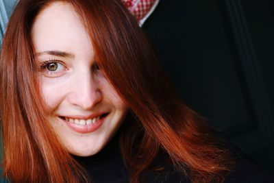 Close-up portrait of a smiling young woman