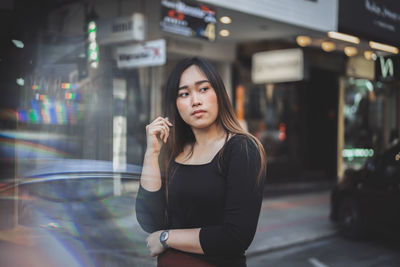 Portrait of a young woman standing outdoors