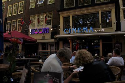 People at sidewalk cafe in city