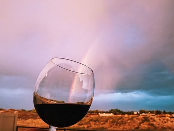 Close-up of wine glass against landscape