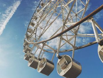 Low angle view of ferris wheel against blue sky