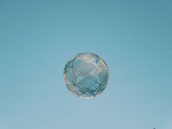 Low angle view of kite against blue sky