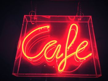 Low angle view of neon cafe sign at night