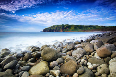 Rocks on beach against sky